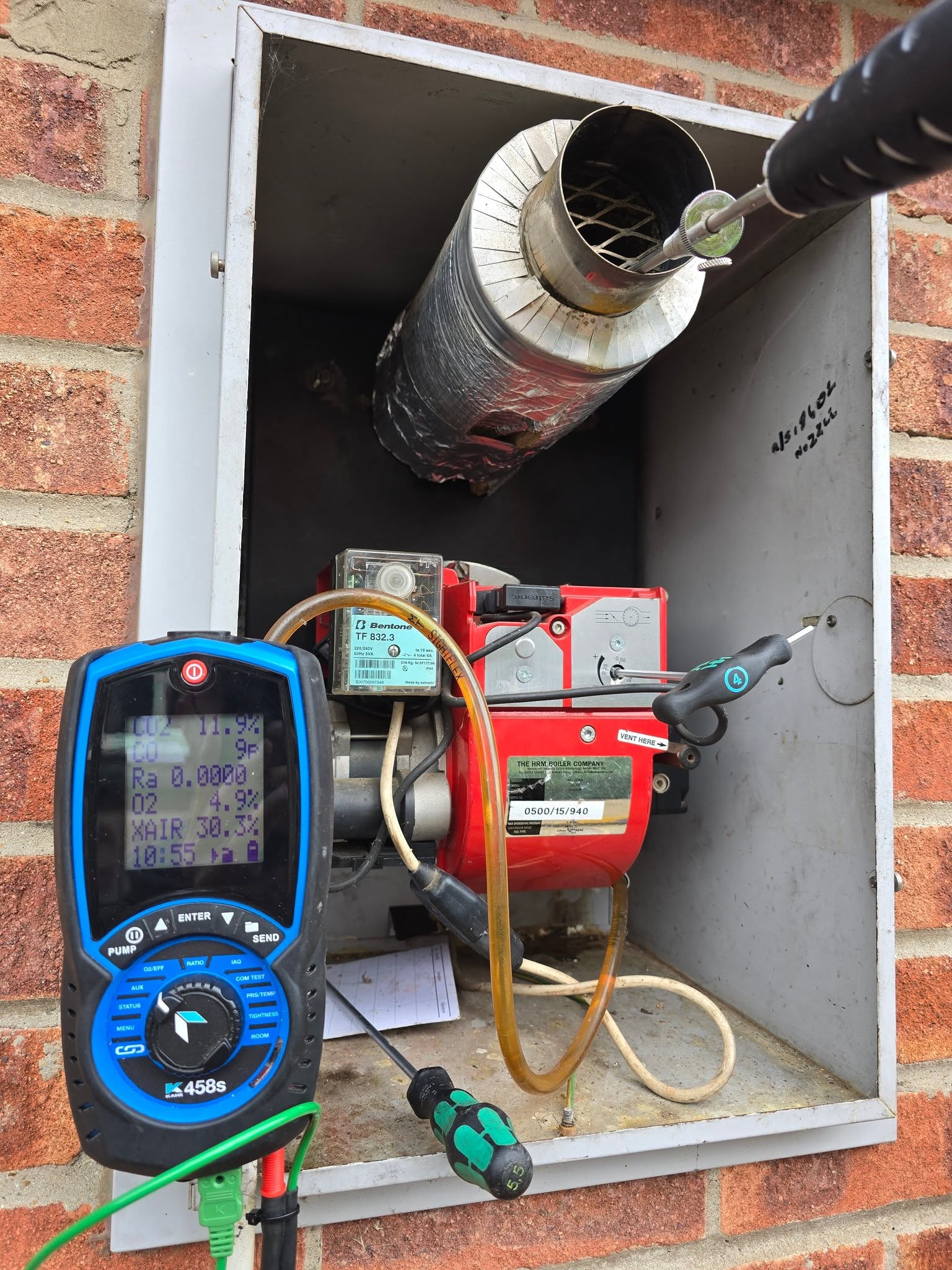 A flue gas analyser connected to an outdoor boiler