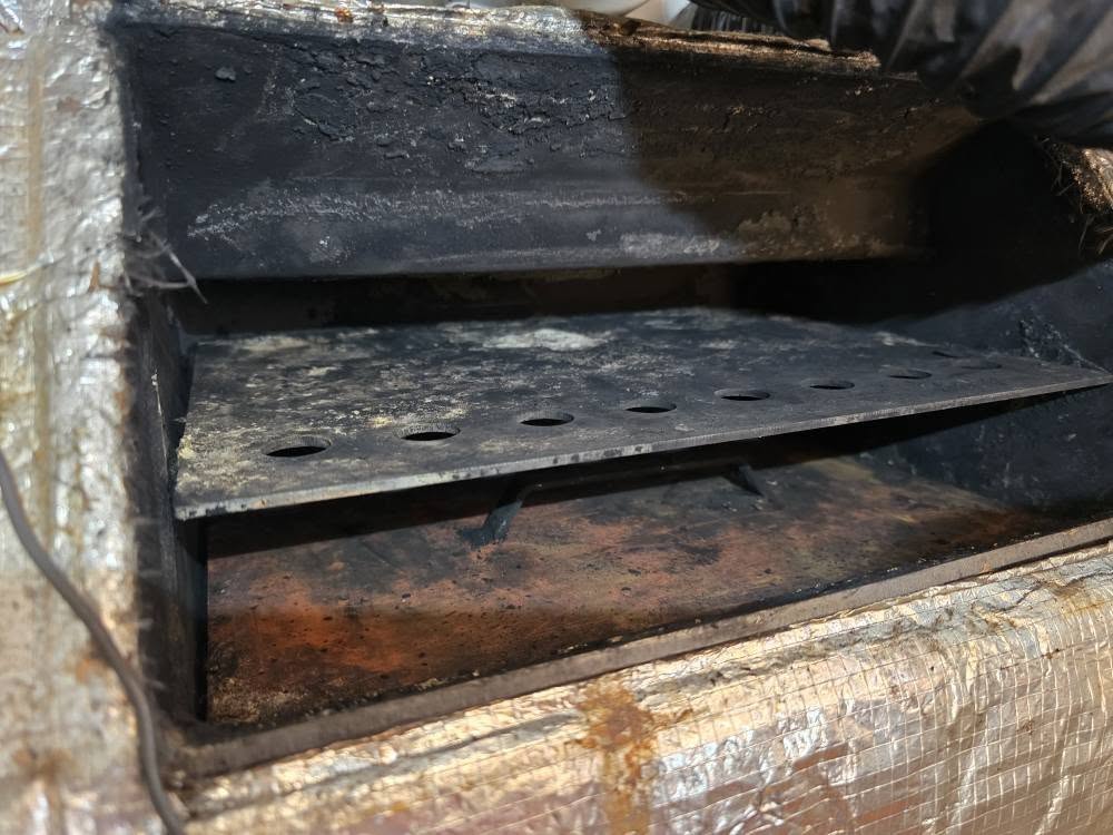 Sooted heat exchanger baffles inside a boiler opened up for a service