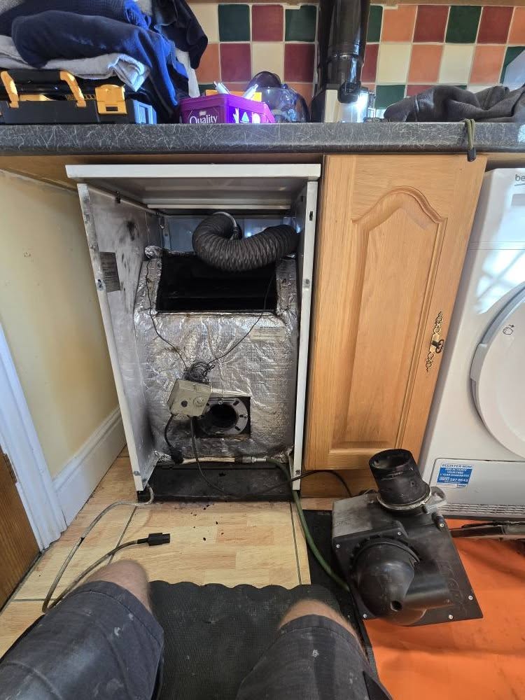 A kitchen boiler opened up with its burner removed